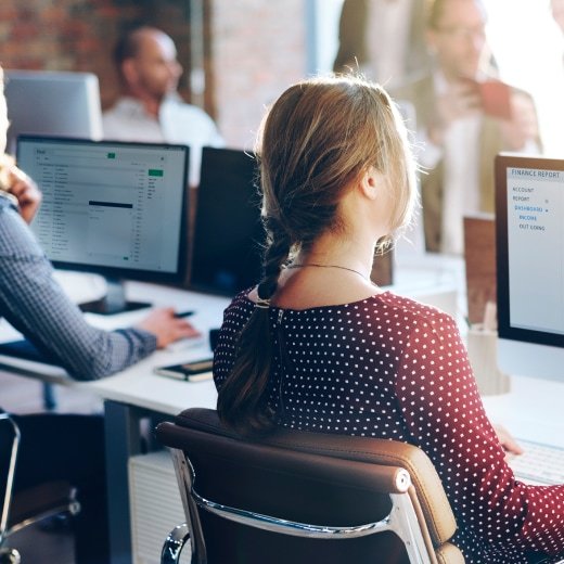 People sitting in an office in front of their computers.