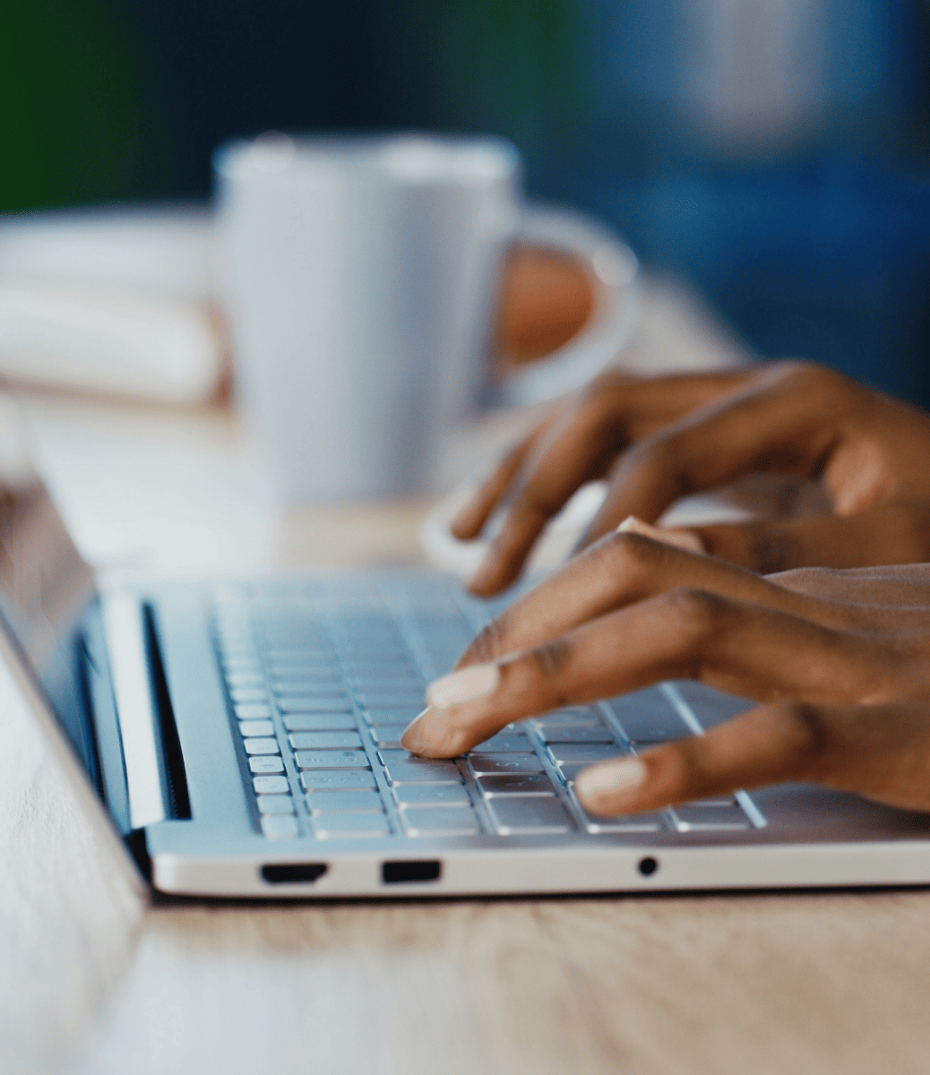 Hands typing on a laptop.