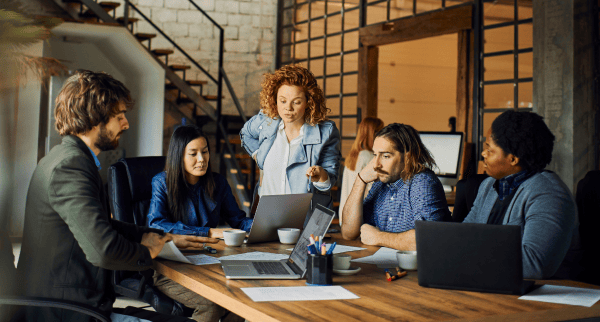 Coworkers in a meeting in an open-plan office.